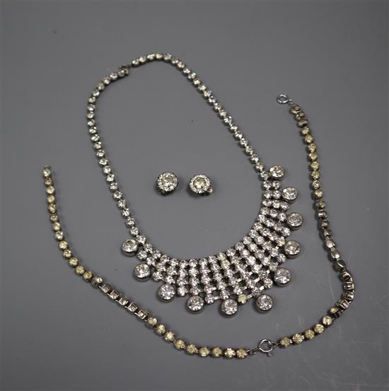 A white metal and paste set fringe necklace, two paste bracelets and a pair of earrings.